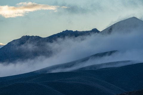Fog rolling over foothills at dusk