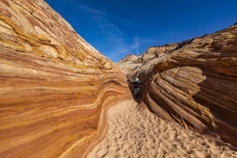 Senior hiker walking in sandstone canyon