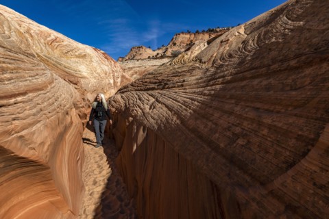 Senior hiker walking in sandstone canyon