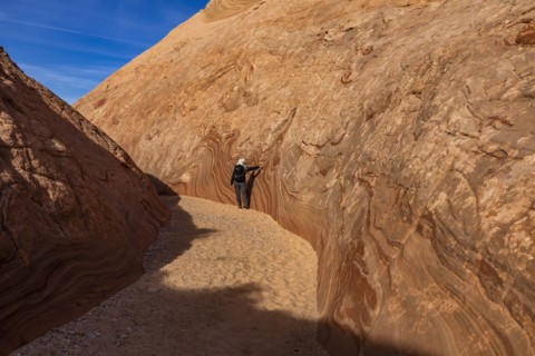 Senior hiker walking in sandstone canyon