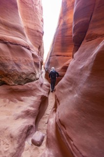 Senior hiker exploring slot canyon