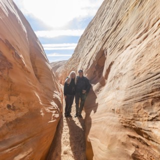 Senior hiker couple exploring slot canyon