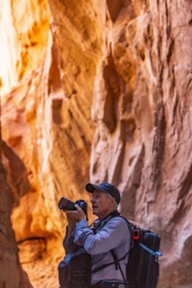 Senior hiker exploring and photographing rock formations in Kodachrome Basin State Park near Escalante Grand Staircase National Monument