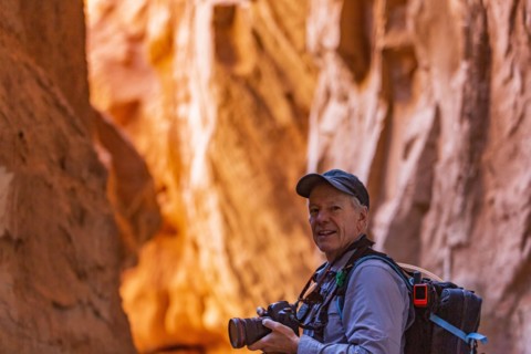 Senior hiker exploring and photographing rock formations in Kodachrome Basin State Park near Escalante Grand Staircase National Monument