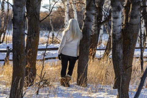 Senior woman posing in winter forest