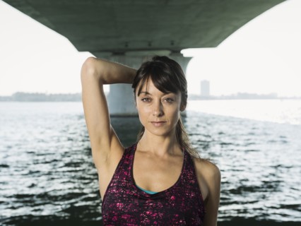 Portrait of woman in sleeveless top under bridge