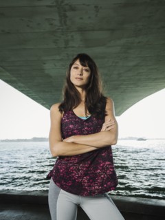 Portrait of woman in sleeveless top under bridge