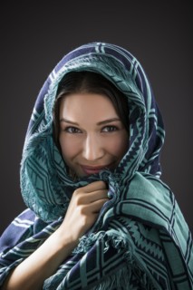 Studio portrait of smiling woman with shawl on head