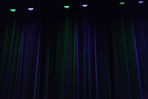 Stage curtain illuminated in green and blue