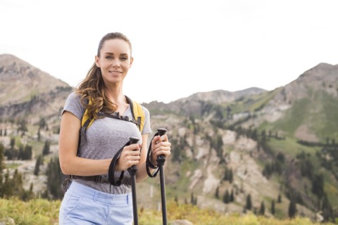 Portrait of smiling woman hiking in mountains