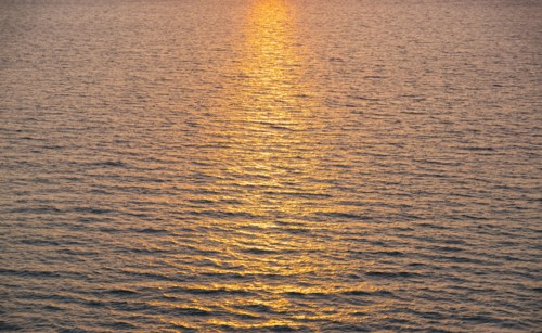 Rippled ocean surface reflecting sunlight