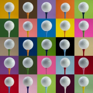 Golf balls on tee against multi colored background