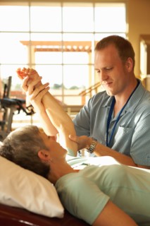 Physical therapist working with patient