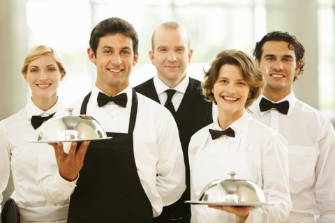 Group of waiters carrying trays