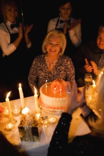 Group of friends celebrating birthday in restaurant