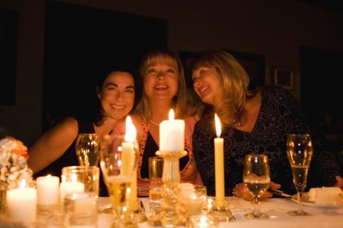 Group of friends celebrating birthday in restaurant
