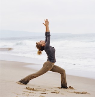 Woman doing yoga on beach