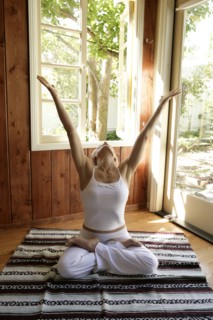 Mature woman practicing yoga at home
