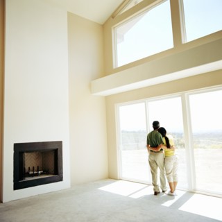 Couple embracing in living room of new home