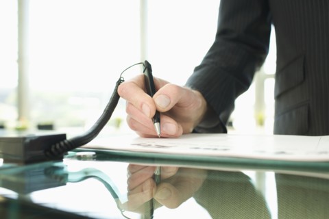 Man signing in at reception desk