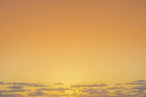 Golden sunrise sky with low clouds