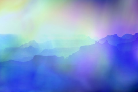 Silhouettes of rock formations in blue light at sunset