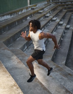 Athletic man running up steps