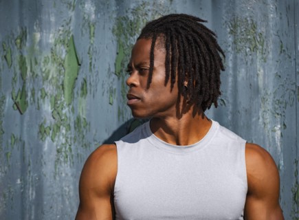Portrait of athlete man against wall