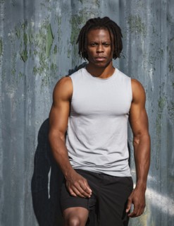 Portrait of athletic man against wall