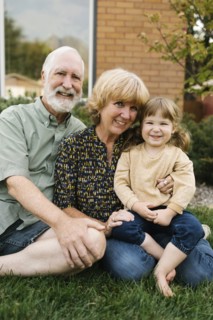 Portrait of smiling grandparents with granddaughter
