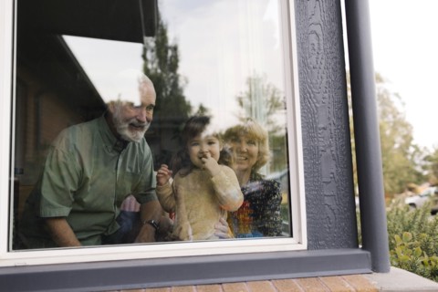 Smiling grandparents with granddaughter