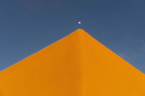 Moon over adobe pueblo building