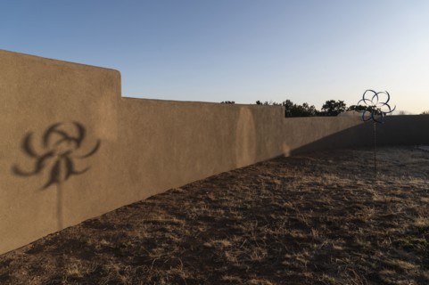 Barren desert garden with decorative wind spinner