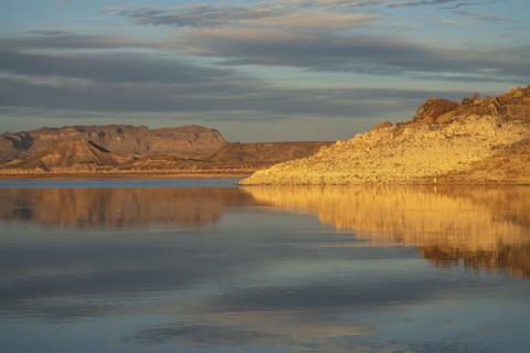 Rock formations reflected in water in Elephant Butte Lake State Park