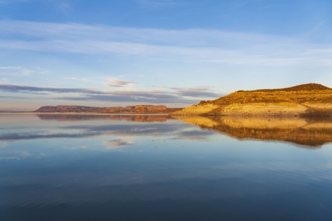 Rock formations reflected in water in Elephant Butte Lake State Park