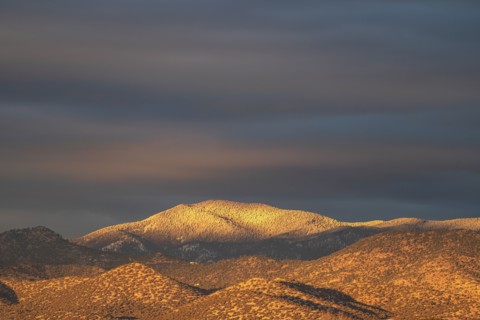 Light snow on Sangre de Cristo Mountains at sunset