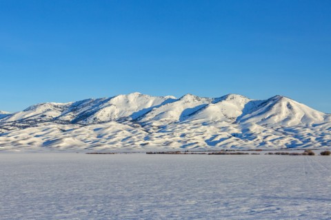 Snow covered field and Soldier Mountain on sunny day