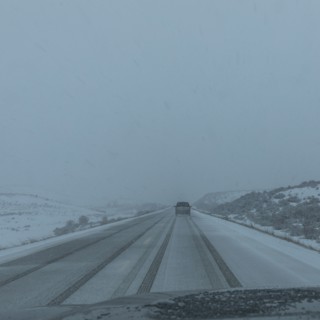Snow covered rural road seen from car