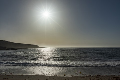 Sun setting over ocean