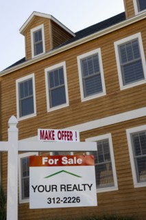 For Sale sign in front of house