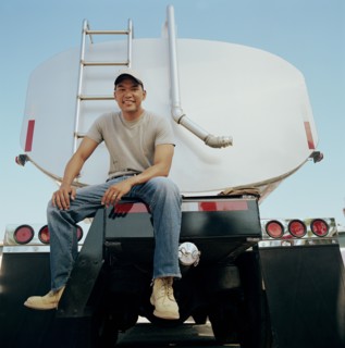 Truck driver sitting on his vehicle