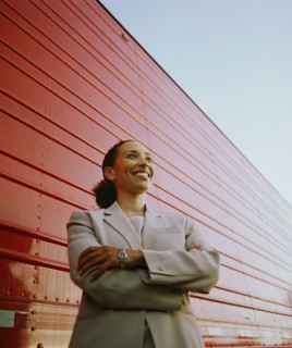 Businesswoman standing next to cargo container