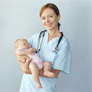 Portrait of doctor holding baby girl