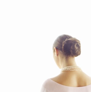 Rear view of woman wearing pearl necklace