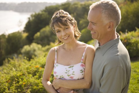 Smiling couple embracing in garden