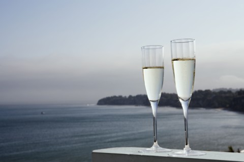 Two glasses of champagne with sea in background