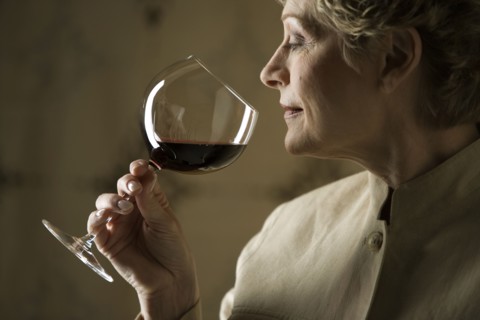 Woman smelling glass of red wine