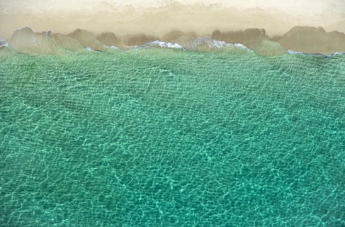 Overhead view of turquoise ocean and beach