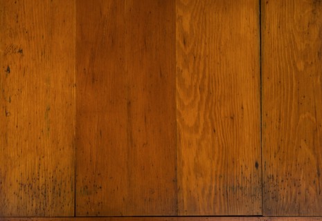 Close-up of worn antique cutting board with knife cut marks