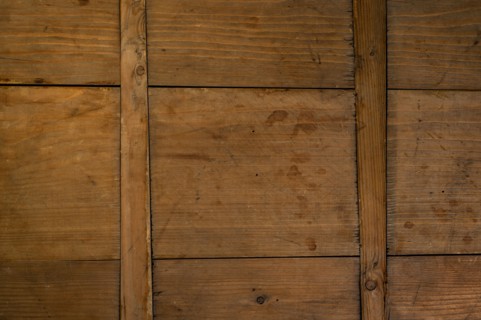 Close-up of worn antique cutting board with cross support wood slats